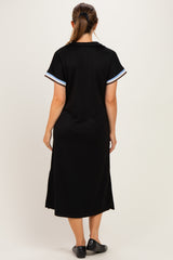 woman wearing a black maternity dress with short sleeves and striped details on the sleeves, view from the back