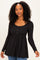 woman wearing a black long sleeve peplum top with buttons and a flared hem