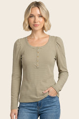 woman wearing a cream and olive striped long sleeve top with button details and puff sleeves