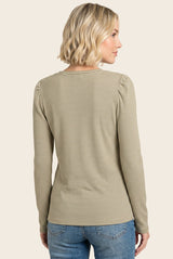woman wearing a striped long sleeve top with gathered shoulder details and back view, paired with blue jeans