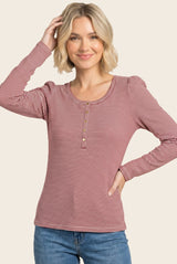 woman wearing a red and white striped long sleeve top with puff sleeves and button detail