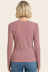 woman wearing a red and white striped long sleeve top, viewed from the back