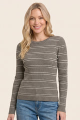 woman wearing a gray ribbed long sleeve top with white stripes and smiling