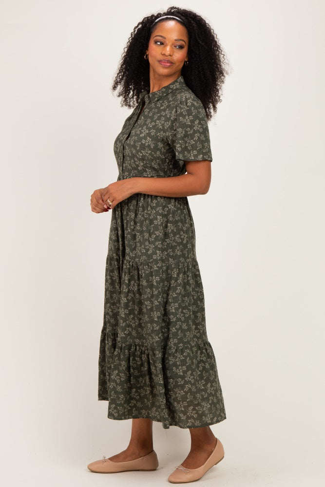 woman wearing a dark green floral print midi dress with short sleeves and a tiered skirt
