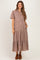 woman wearing a mauve maternity dress with short sleeves, button front, and tiered design, showing a baby bump