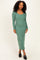 woman wearing a long sleeve ribbed green midi dress and black slip-on shoes