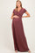 woman wearing a burgundy short sleeve maternity maxi dress and holding her baby bump
