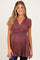 woman wearing a maroon maternity top with a wrap style and short sleeves, showcasing her baby bump