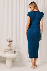 woman wearing a teal ribbed midi dress with cap sleeves, standing with her back to the camera