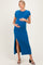 woman wearing a blue ribbed maternity dress with a side slit and holding her baby bump