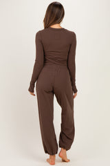 woman wearing a brown long sleeve maternity loungewear set with cinched pants and a relaxed fit