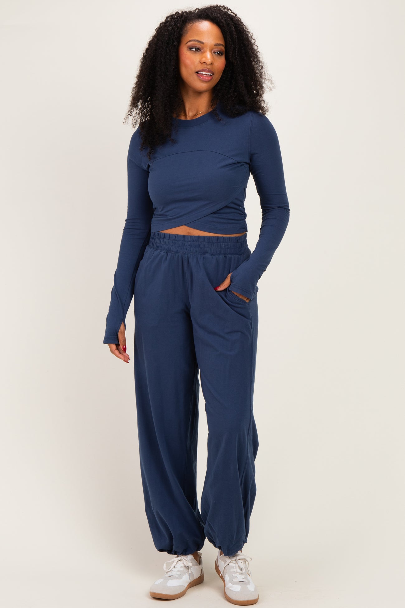 woman wearing a navy blue long sleeve cropped top and matching wide-leg pants with a relaxed fit