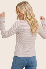 woman wearing a thin striped long sleeve top with a round neck and back view, paired with light blue jeans