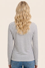 woman wearing a gray and white striped long sleeve top, viewed from the back
