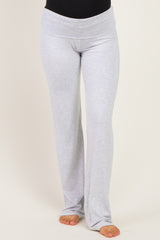woman wearing gray maternity lounge pants with a wide waistband and a relaxed fit