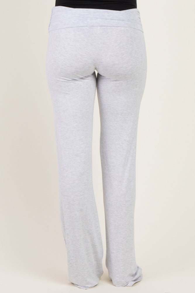 woman wearing gray maternity pants with a fold-over waistband from the back