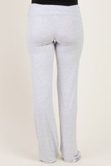 woman wearing gray maternity pants with a fold-over waistband from the back