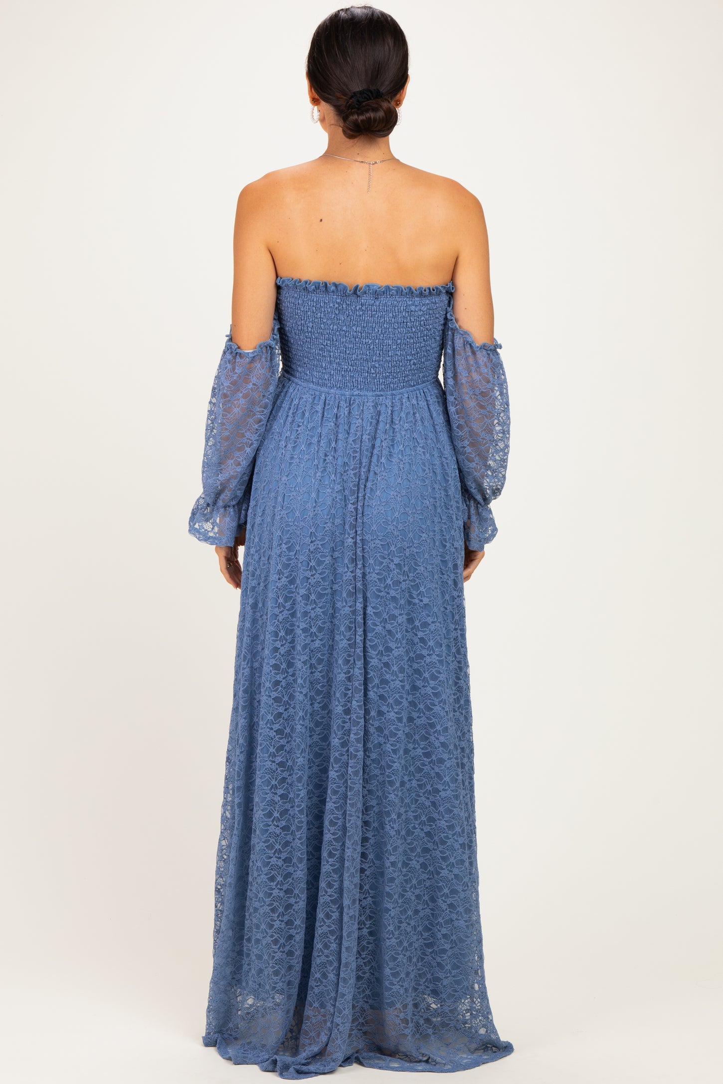 woman wearing a back view of a blue off-the-shoulder long lace maxi dress with puff sleeves