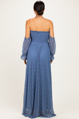 woman wearing a back view of a blue off-the-shoulder long lace maxi dress with puff sleeves
