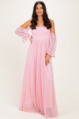 woman wearing a pink off-shoulder maxi dress with smocked bodice and bell sleeves