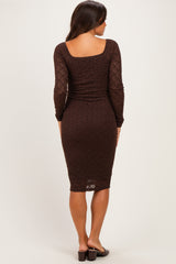 woman wearing a brown long sleeve maternity dress with a fitted silhouette, viewed from the back