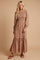 woman wearing a long floral maxi dress with smocked bodice and tiered hem, standing on a neutral background