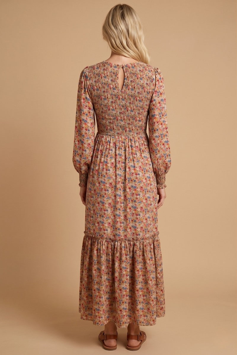 woman wearing a long floral maxi dress with smocked bodice and tiered skirt, seen from the back