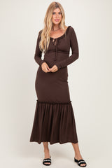 woman wearing a brown ribbed maxi dress with long sleeves and a tie-front detail