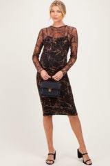 woman wearing a black animal print maternity dress with long sleeves and a fitted silhouette, holding a black handbag