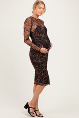 woman wearing a brown animal print long sleeve maternity dress and holding her baby bump