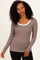 woman wearing a brown and cream striped long sleeve top with a scoop neckline and slim fit