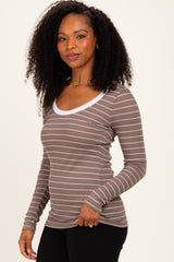 woman wearing a brown and white striped long sleeve top with a scoop neckline and fitted sleeves