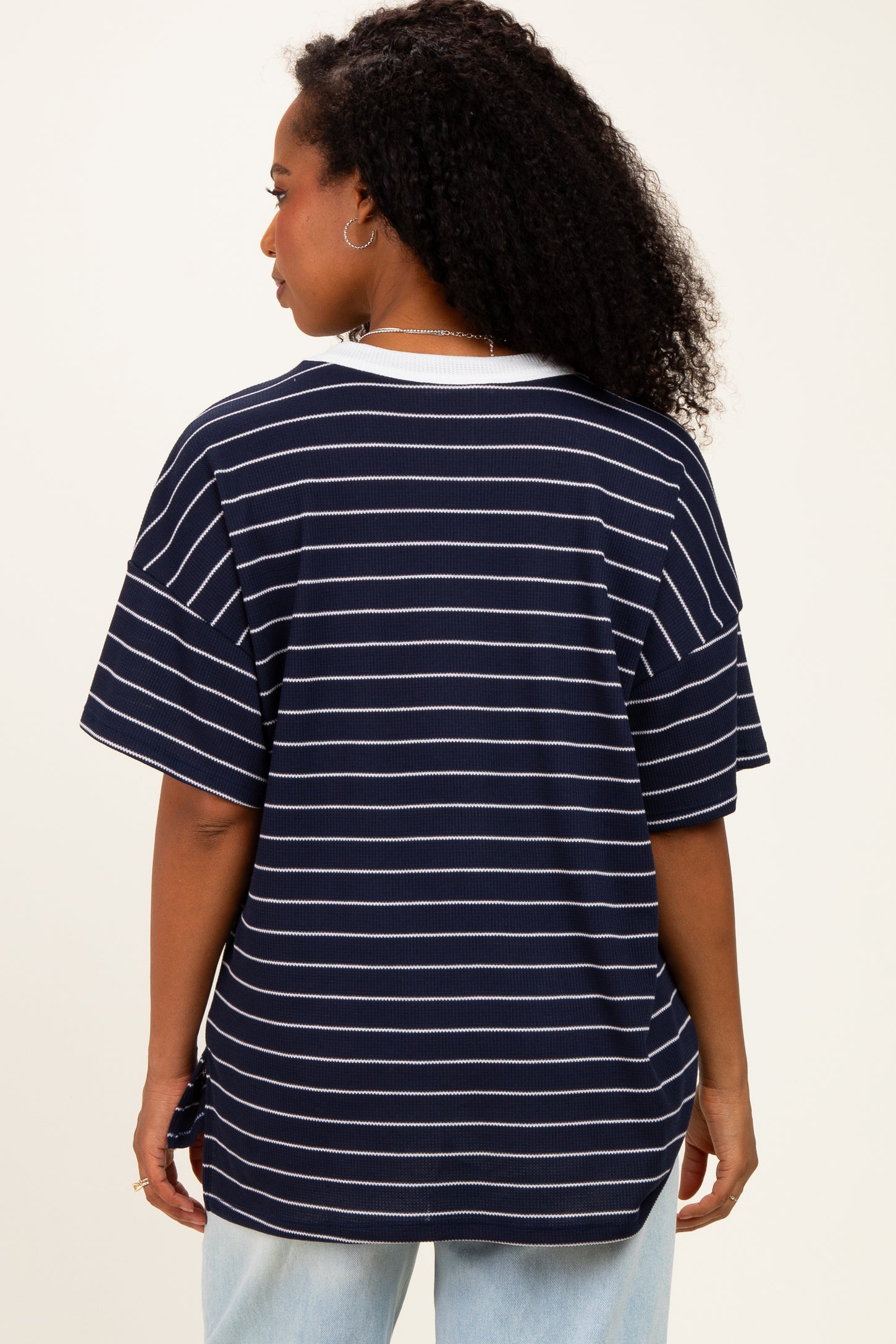 woman wearing a navy striped short sleeve top with a relaxed fit and side tie detail