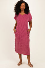 woman wearing a pink striped midi dress with short sleeves and side pockets
