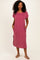 woman wearing a pink striped midi dress with short sleeves and side pockets