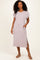 woman wearing a light mauve ribbed short sleeve midi dress with side slits and pockets