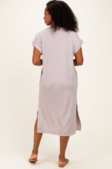 woman wearing a light purple ribbed midi dress with short sleeves and side slits, facing away from the camera