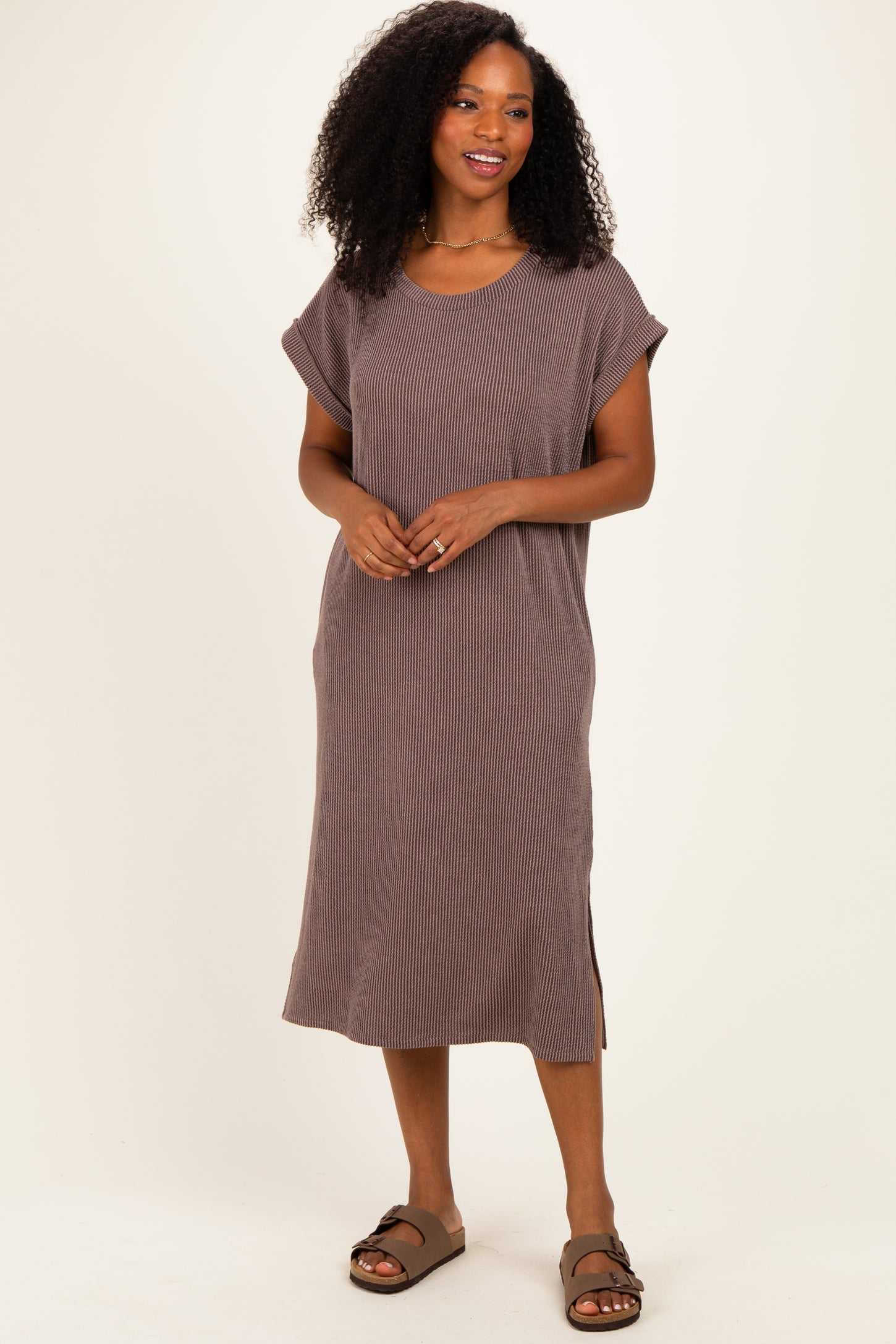woman wearing a brown ribbed short sleeve midi dress with side slits