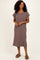 woman wearing a brown ribbed short sleeve midi dress with side slits