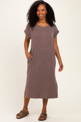 woman wearing a brown striped short sleeve midi dress with pockets and a relaxed fit