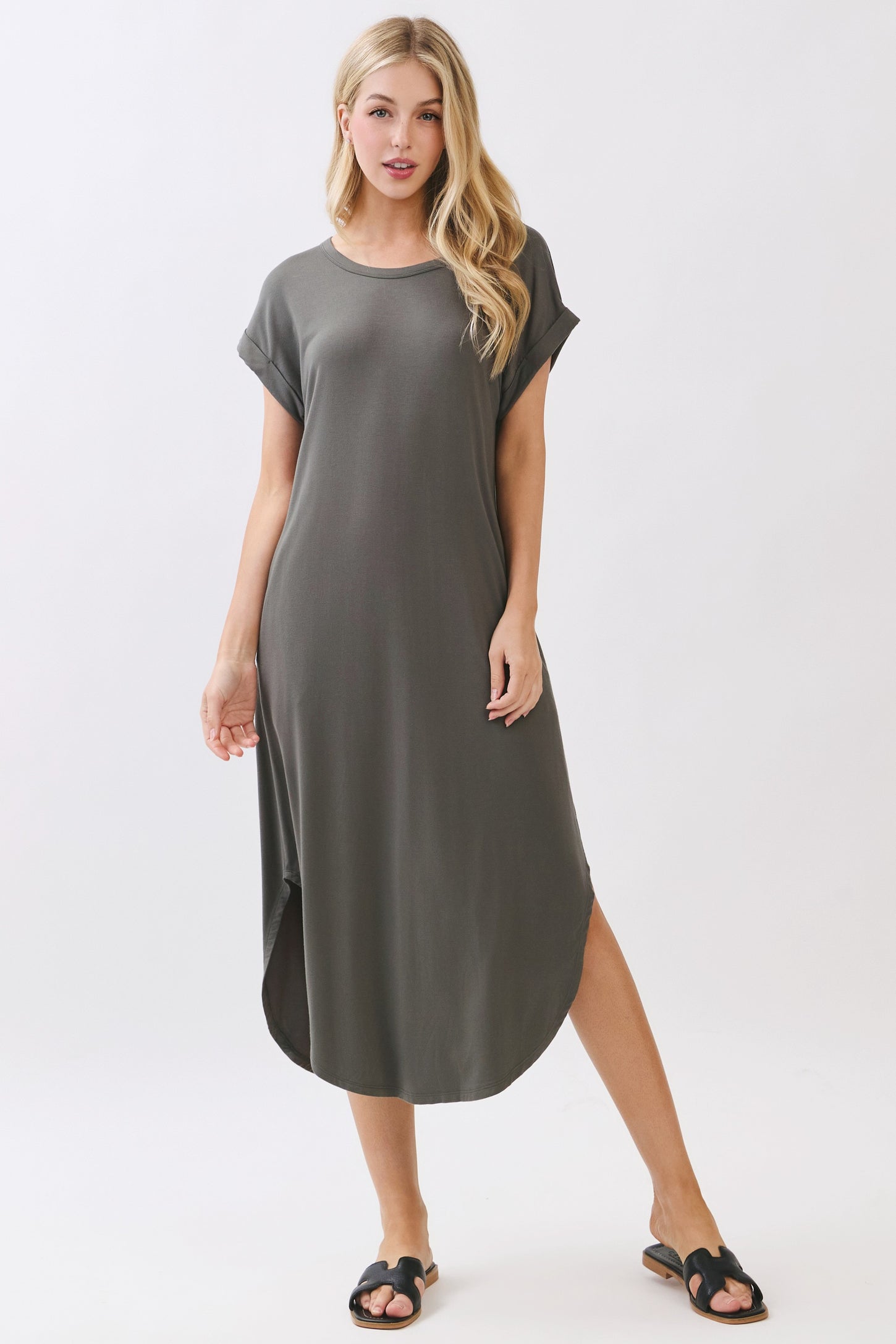 woman wearing a relaxed fit olive green t-shirt dress with short sleeves and side slits