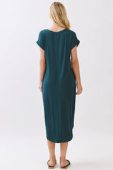 woman wearing a teal short sleeve maxi dress, viewed from the back