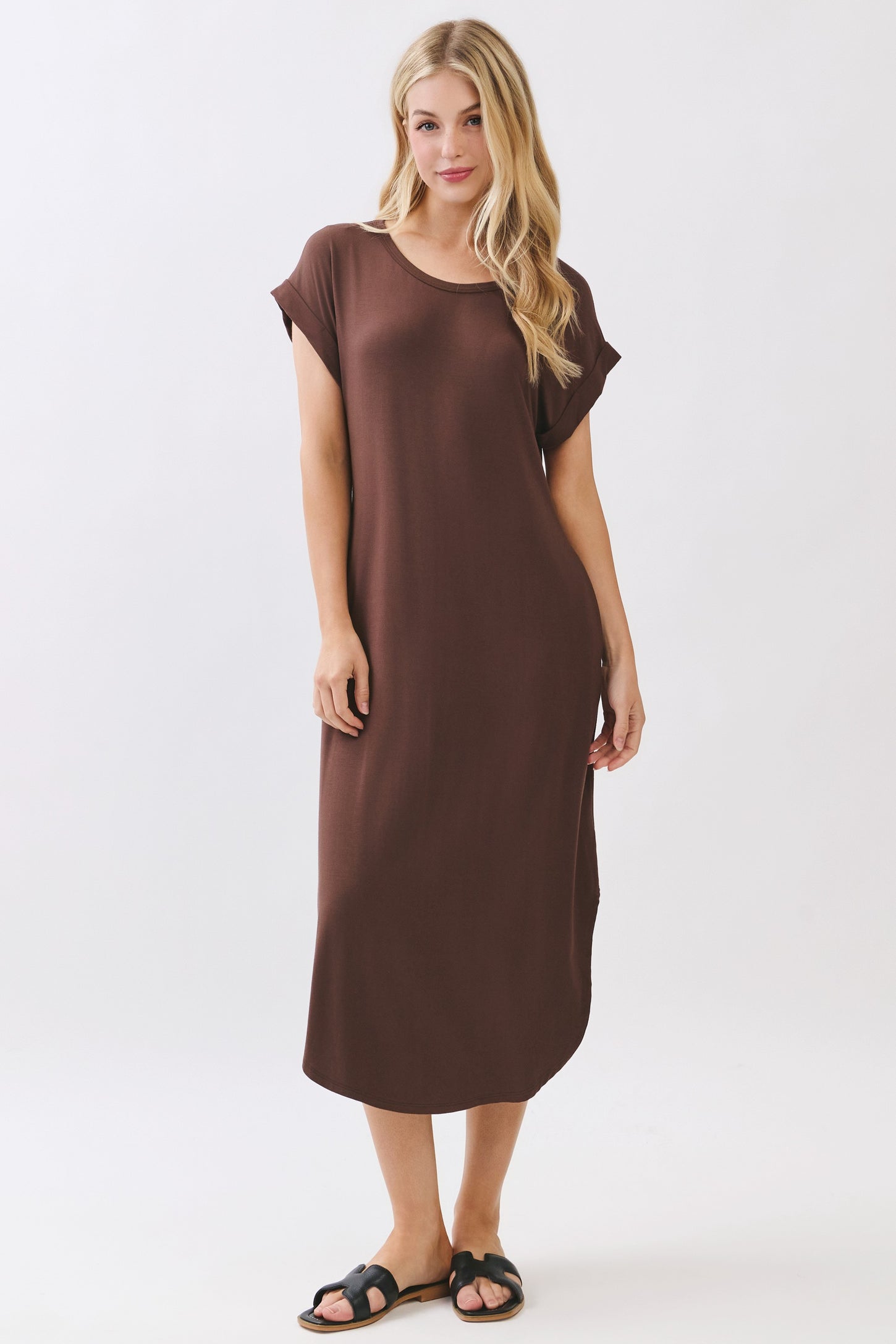 woman wearing a brown short sleeve midi dress and black slide sandals