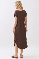 woman wearing a brown short sleeve maxi dress with a side slit and a relaxed fit, seen from the back