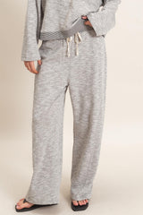 woman wearing gray lounge pants with a relaxed fit and drawstring waistband