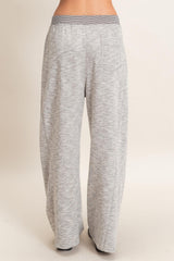 woman wearing light gray wide-leg lounge pants with a relaxed fit and an elastic waistband