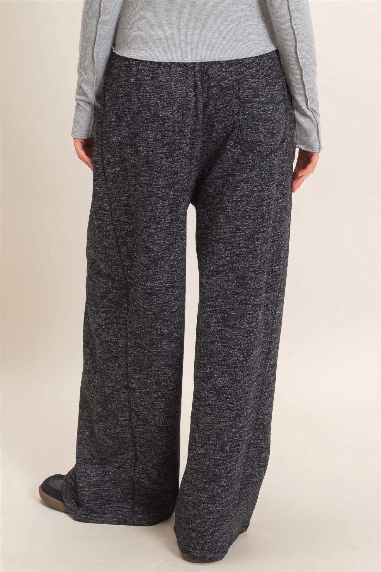 woman wearing gray marled wide-leg lounge pants, viewed from the back