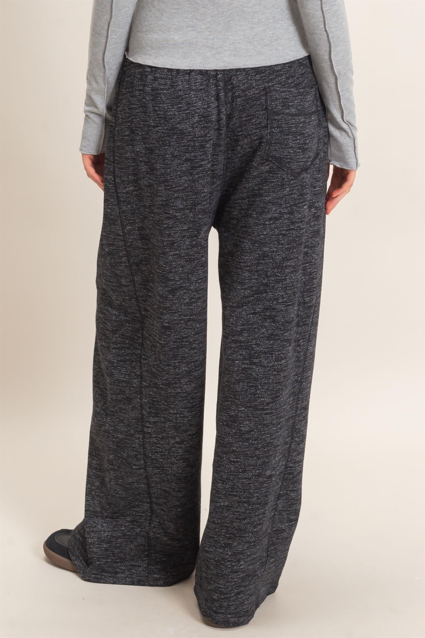 woman wearing gray marled wide-leg lounge pants, viewed from the back