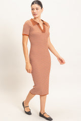 woman wearing a striped midi dress in warm hues of orange and brown with a polo-style collar and short sleeves