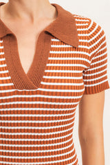 woman wearing a brown and white striped short sleeve polo top with a v-neckline and ribbed texture
